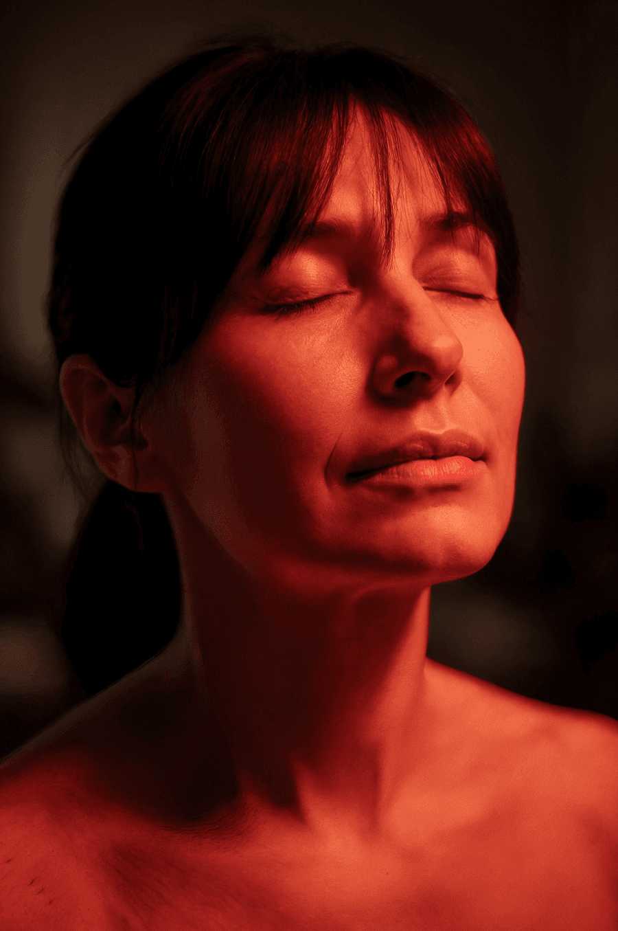 Woman experiencing red light therapy