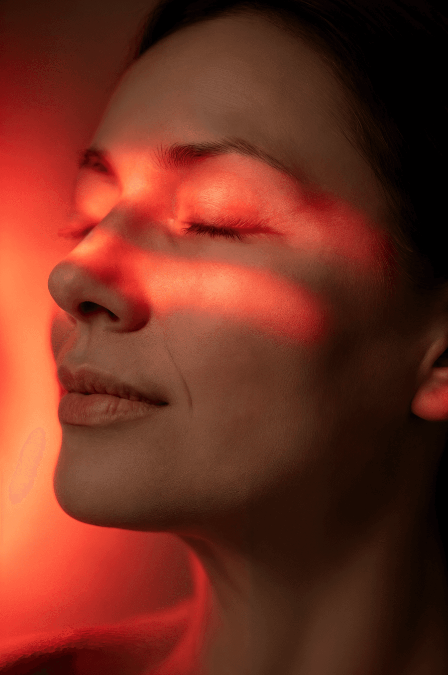 Woman in red light therapy session